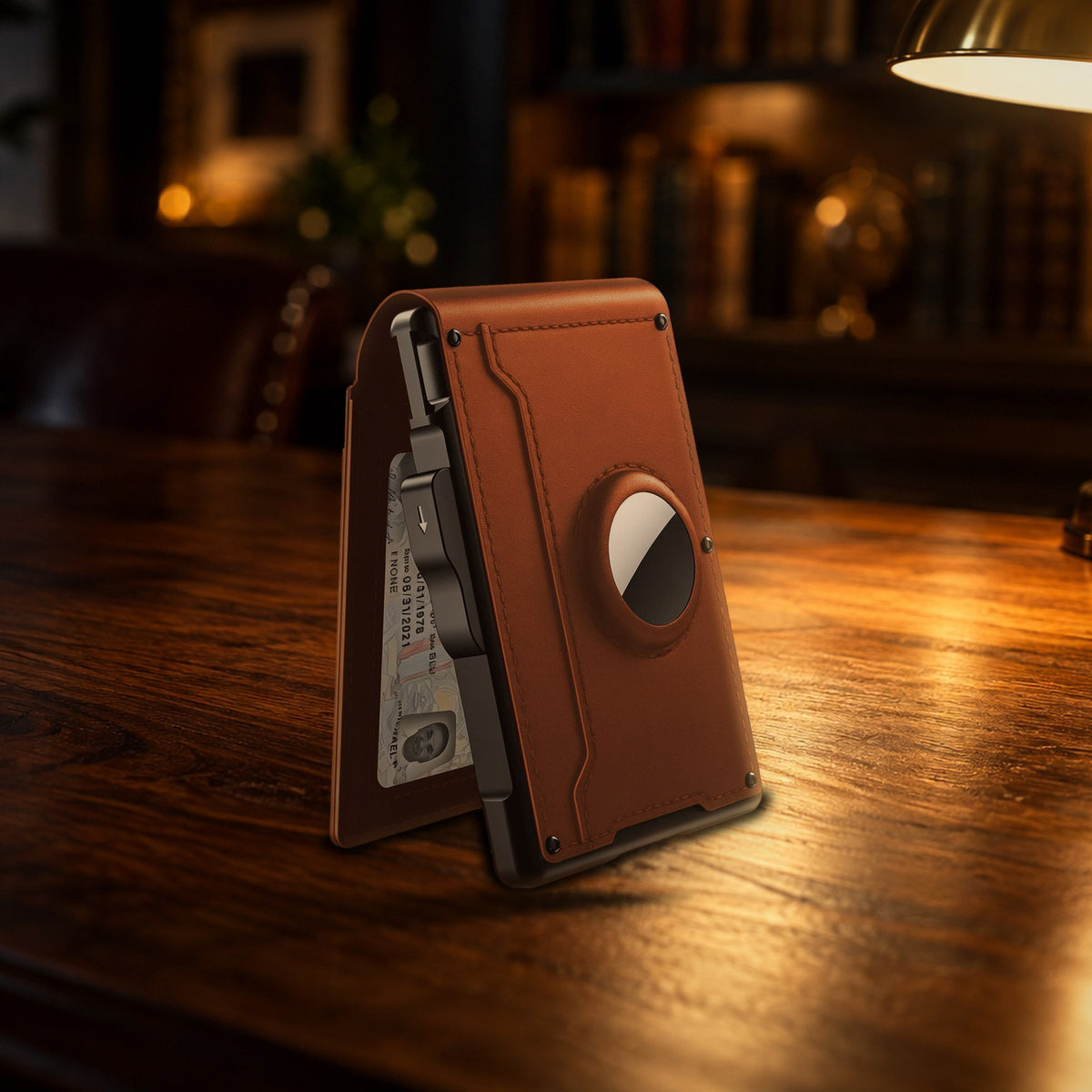 WALV Pop-Up Wallet in Cognac on a walnut desk under a brass lamp, back with the AirTag slot